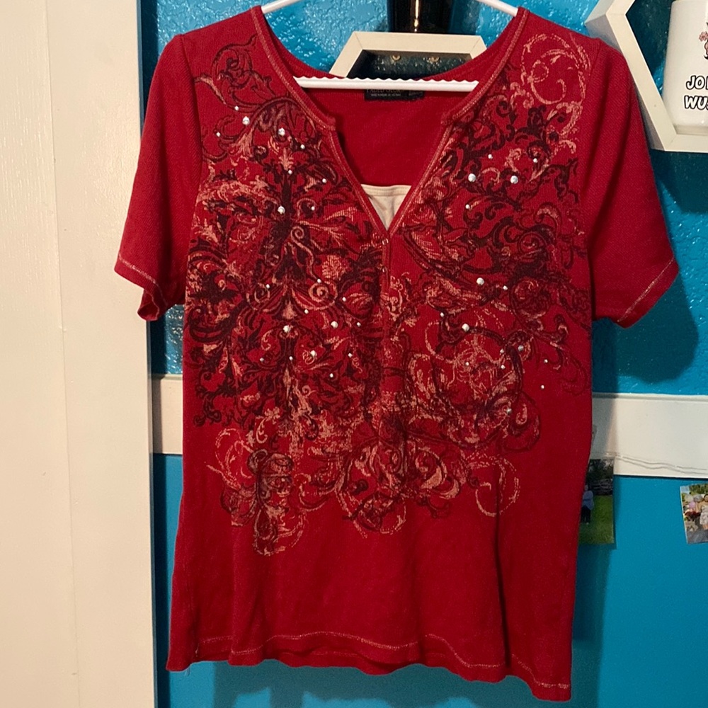 Red t-shirt with little designs and gems